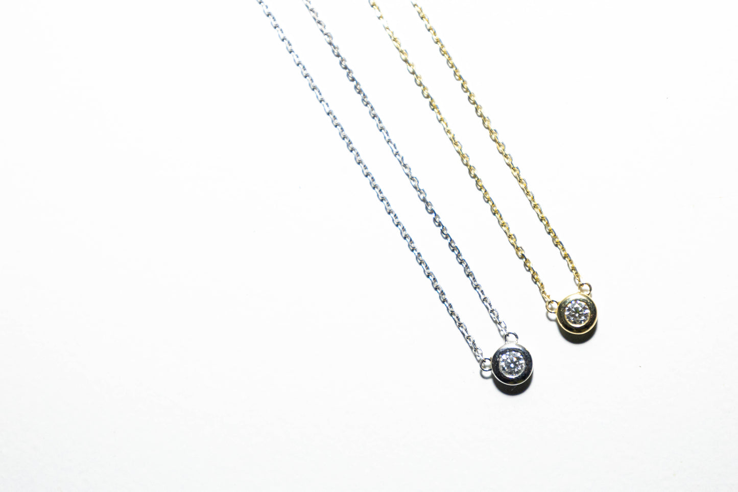 Pair of single diamond necklaces in 14k solid yellow gold and white gold