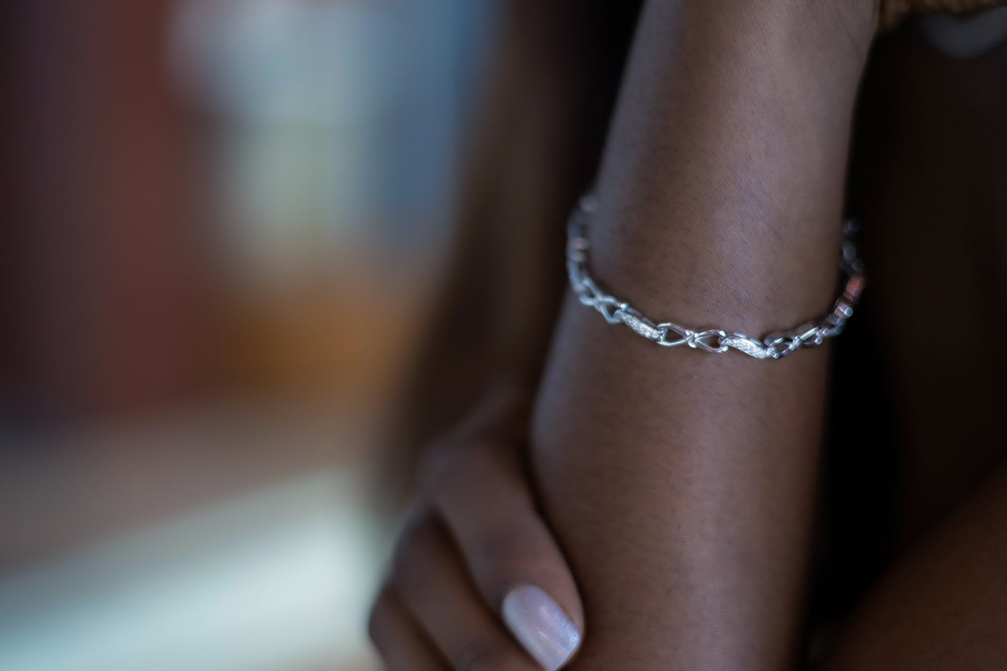 Silver Moissanite Infinity Bracelet on model's arm