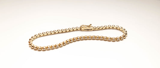 diamond tennis bracelet in a bezel set with round diamonds in 14k solid yellow gold