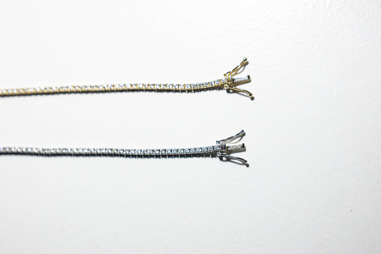 two diamond tennis anklets in white gold and yellow gold